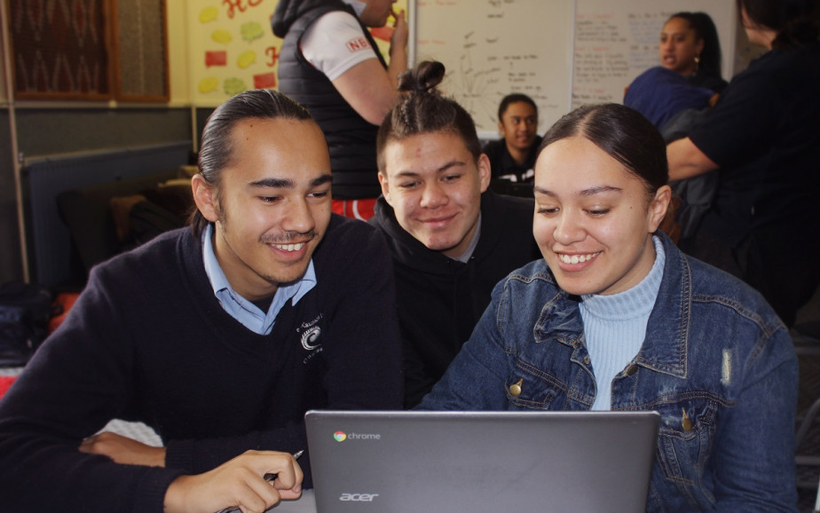 Students looking at a laptop