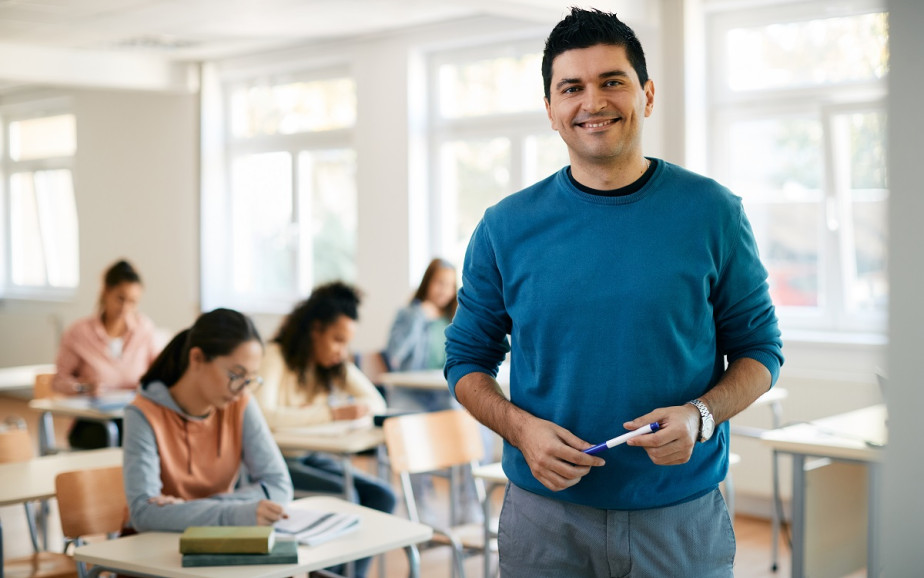 Teacher standing at the front of a class.